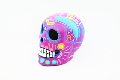 Colorful traditional style tattoo featuring a skull and roses.