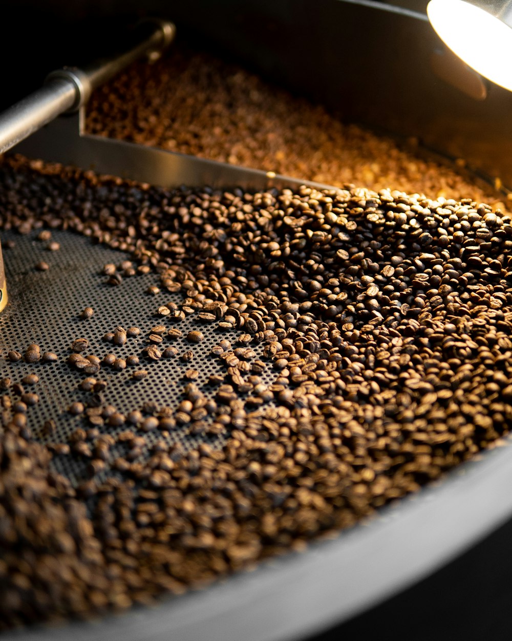 a close up of a machine making coffee beans