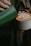 Close-up photo of a smiling barista holding a beautifully crafted latte art cup.