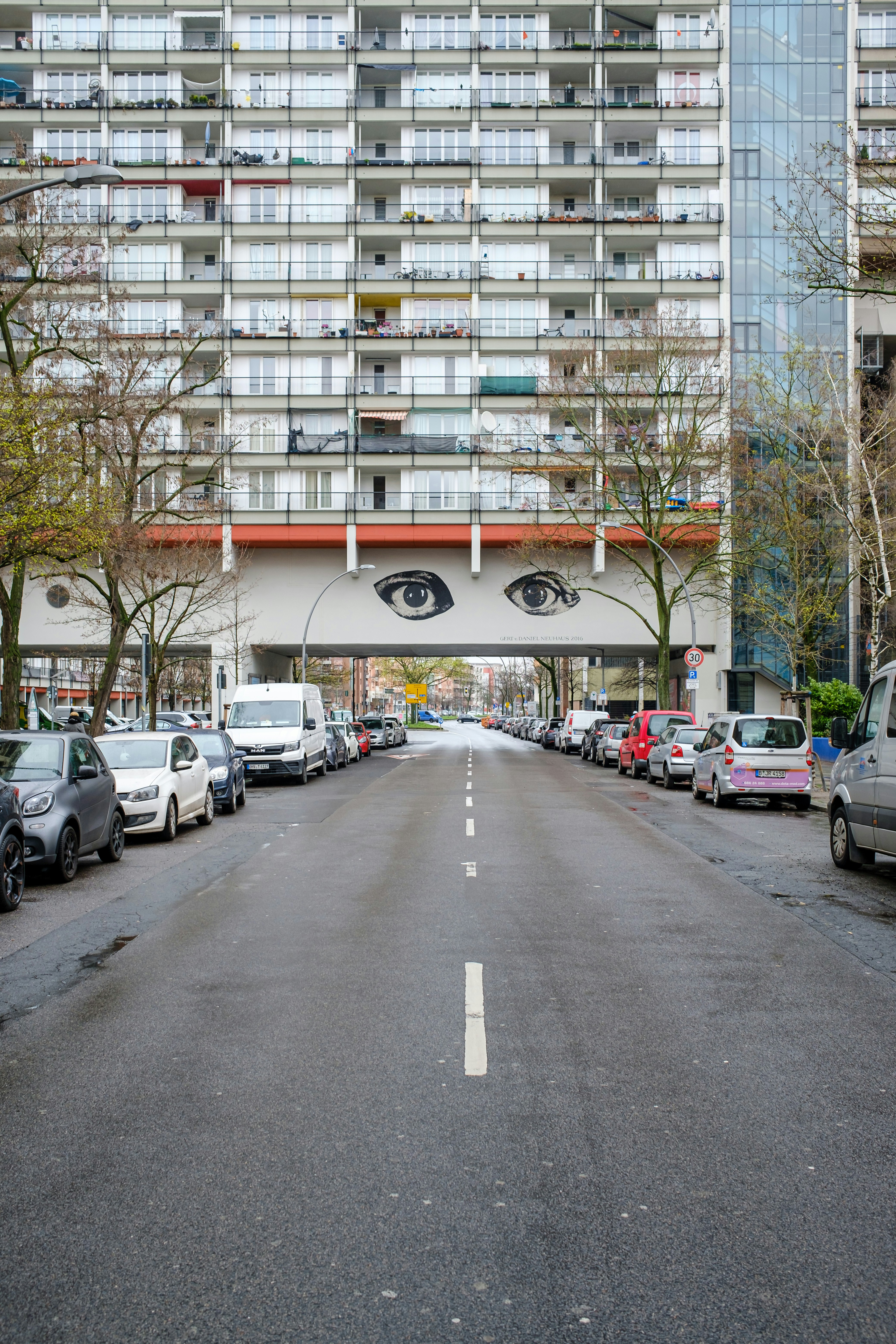 A street with cars parked on both sides of it photo – Free Car Image on ...
