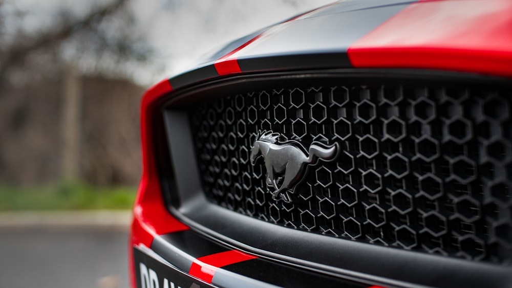 a close up of the front of a red and black car