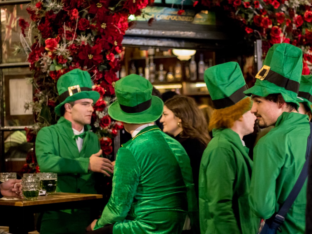 a group of people dressed in green standing next to each other