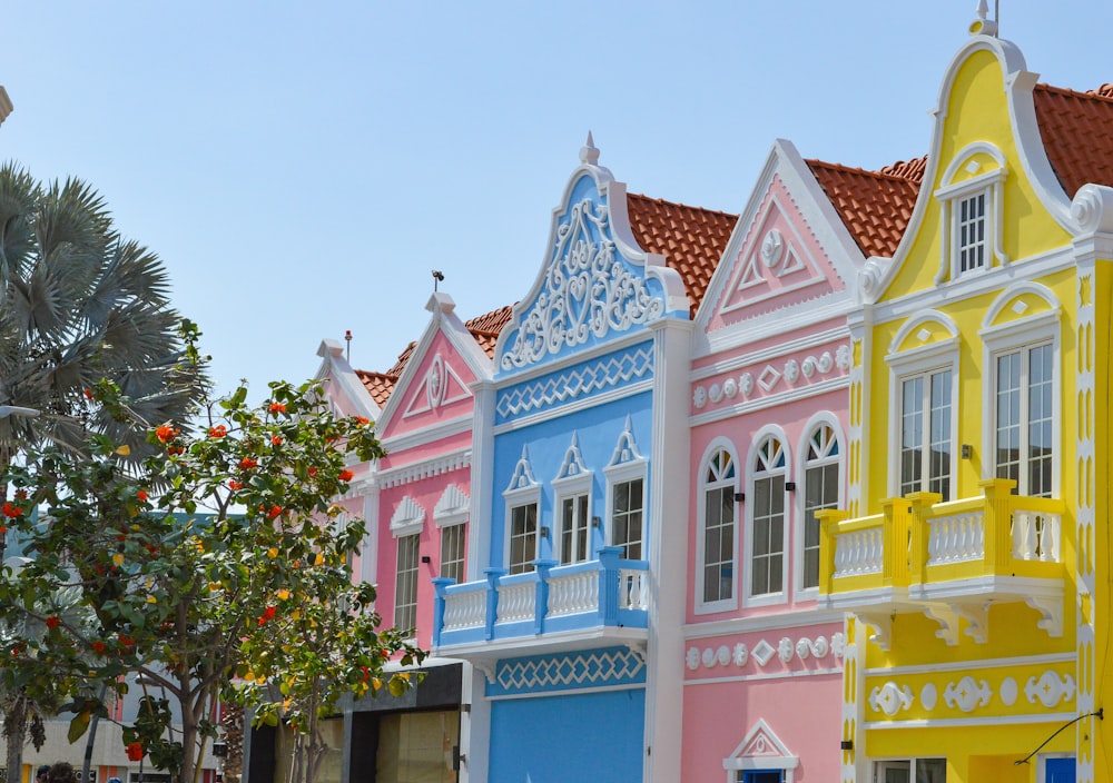 a row of brightly colored houses on a street