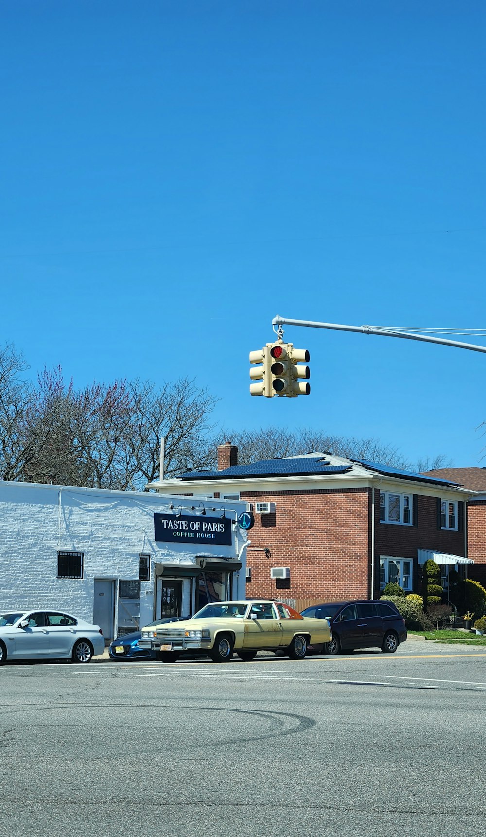 a traffic light hanging over a street next to a building