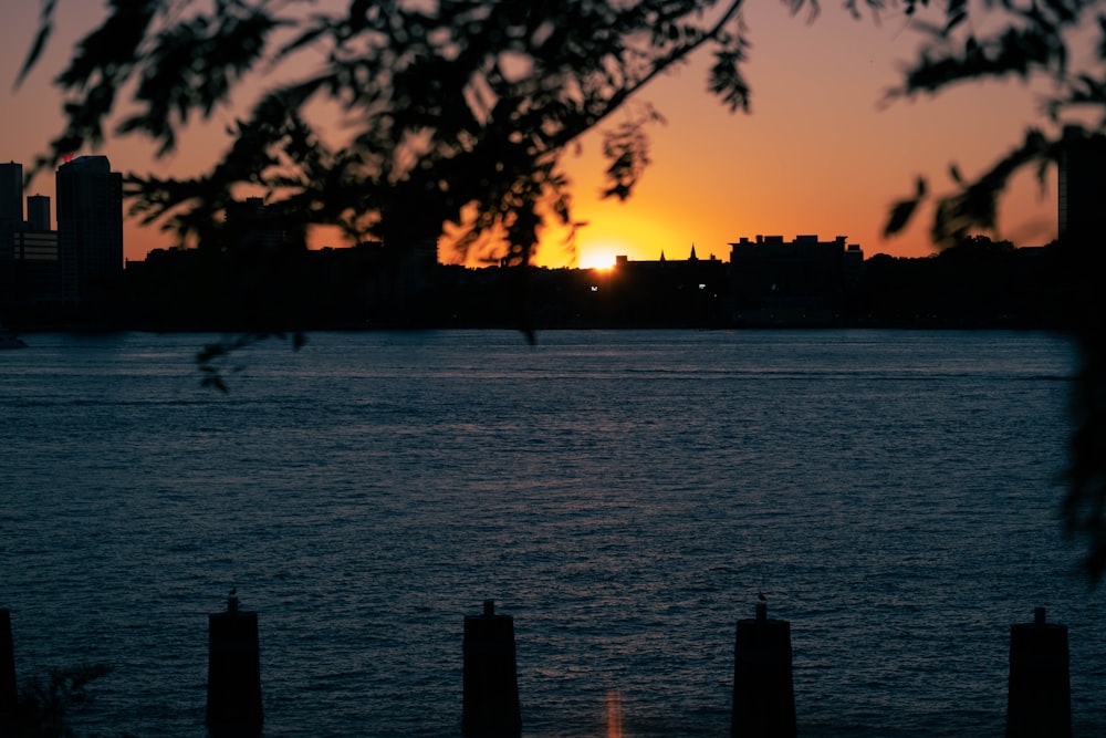 the sun is setting over a body of water