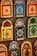 Colorful decorative items resembling miniature window frames are displayed. Each piece is intricately designed with various patterns, featuring bold colors like orange, blue, yellow, and green. Some have small wooden doors with detailed carvings and floral motifs.
