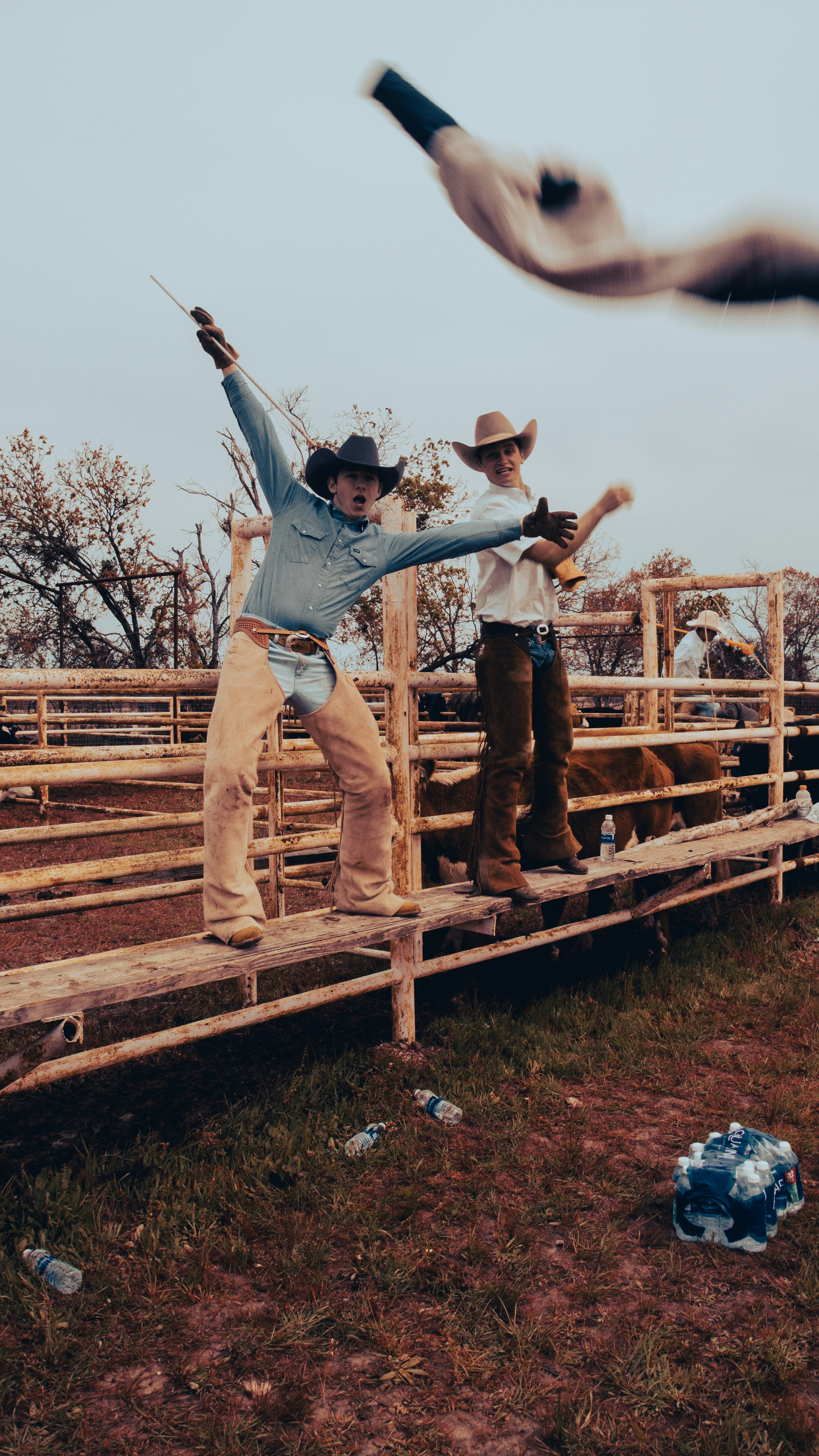 A couple of men standing on top of a wooden fence photo – Free Portrait ...