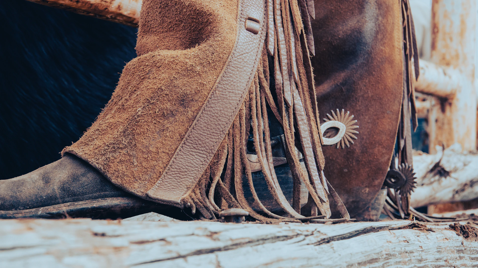 A rugged pair of leather boots and a classic cowboy hat resting on a vintage saddle, evoking authentic country style.