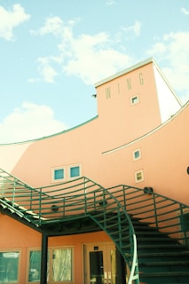 Front view of Wings Services office building with contact information displayed nearby.