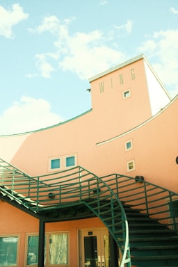 Front view of Wings Services office building with contact information displayed nearby.