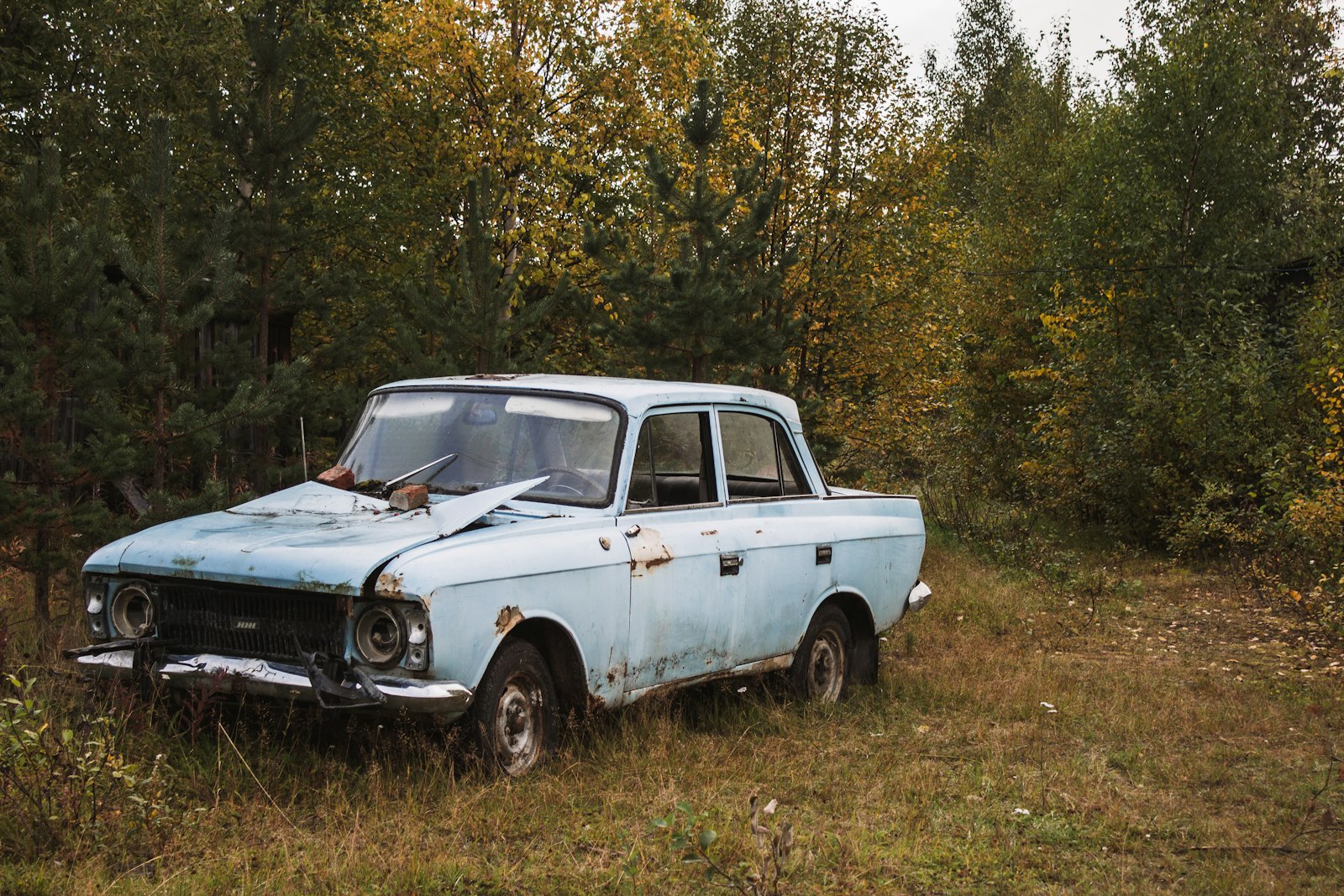 Old junk car parked in field ready to be sold for cash in Calgary Alberta