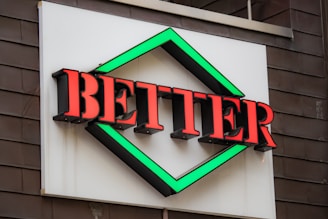 a sign that says better on the side of a building