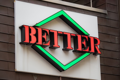a sign that says better on the side of a building