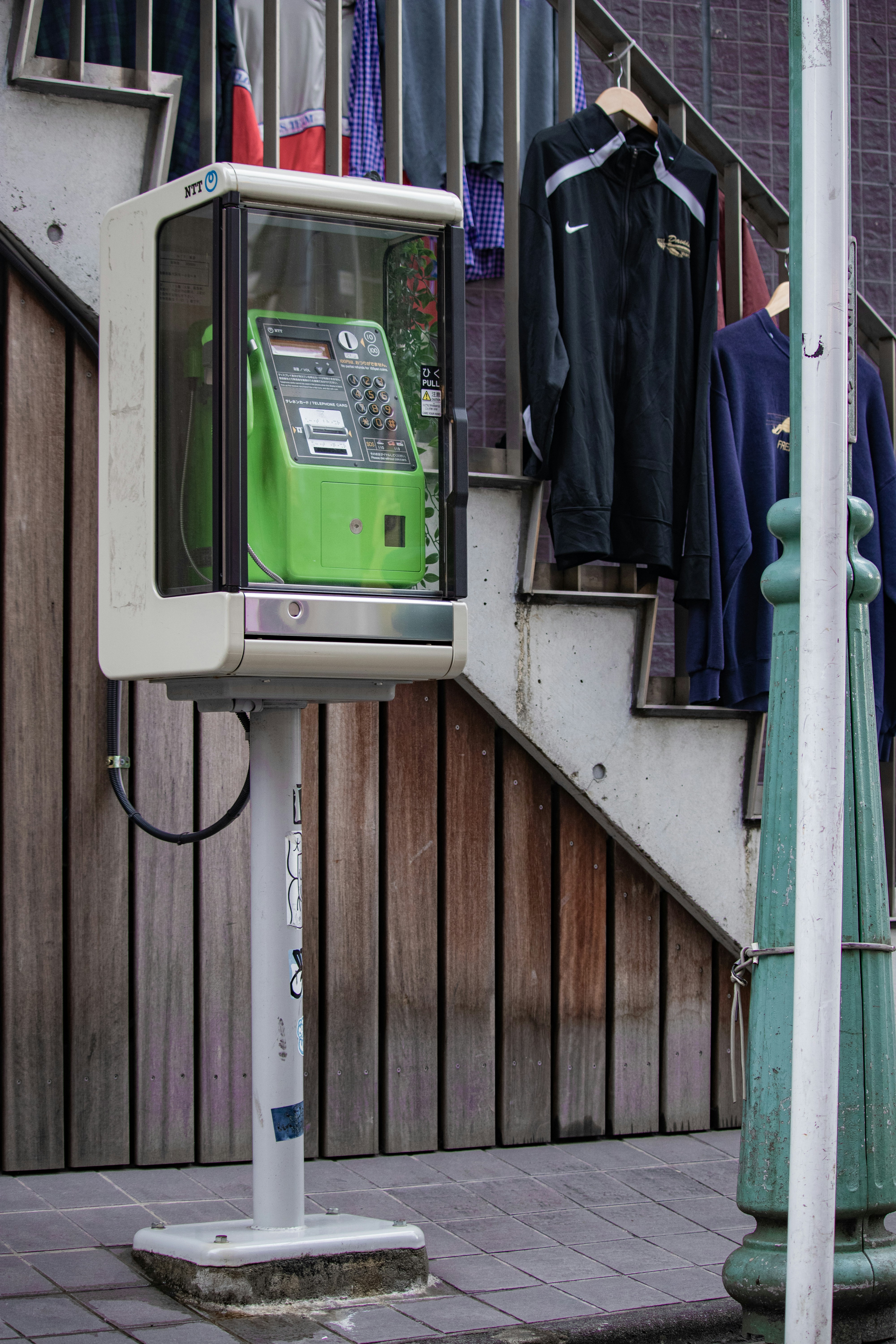 a television sitting on top of a metal pole