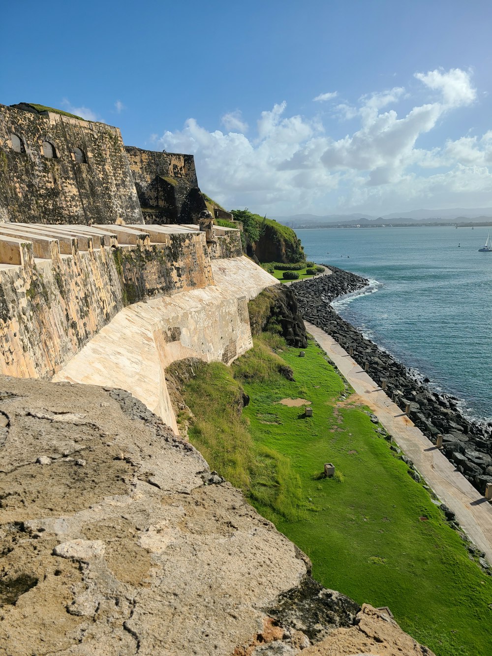 a view of the ocean from the top of a hill