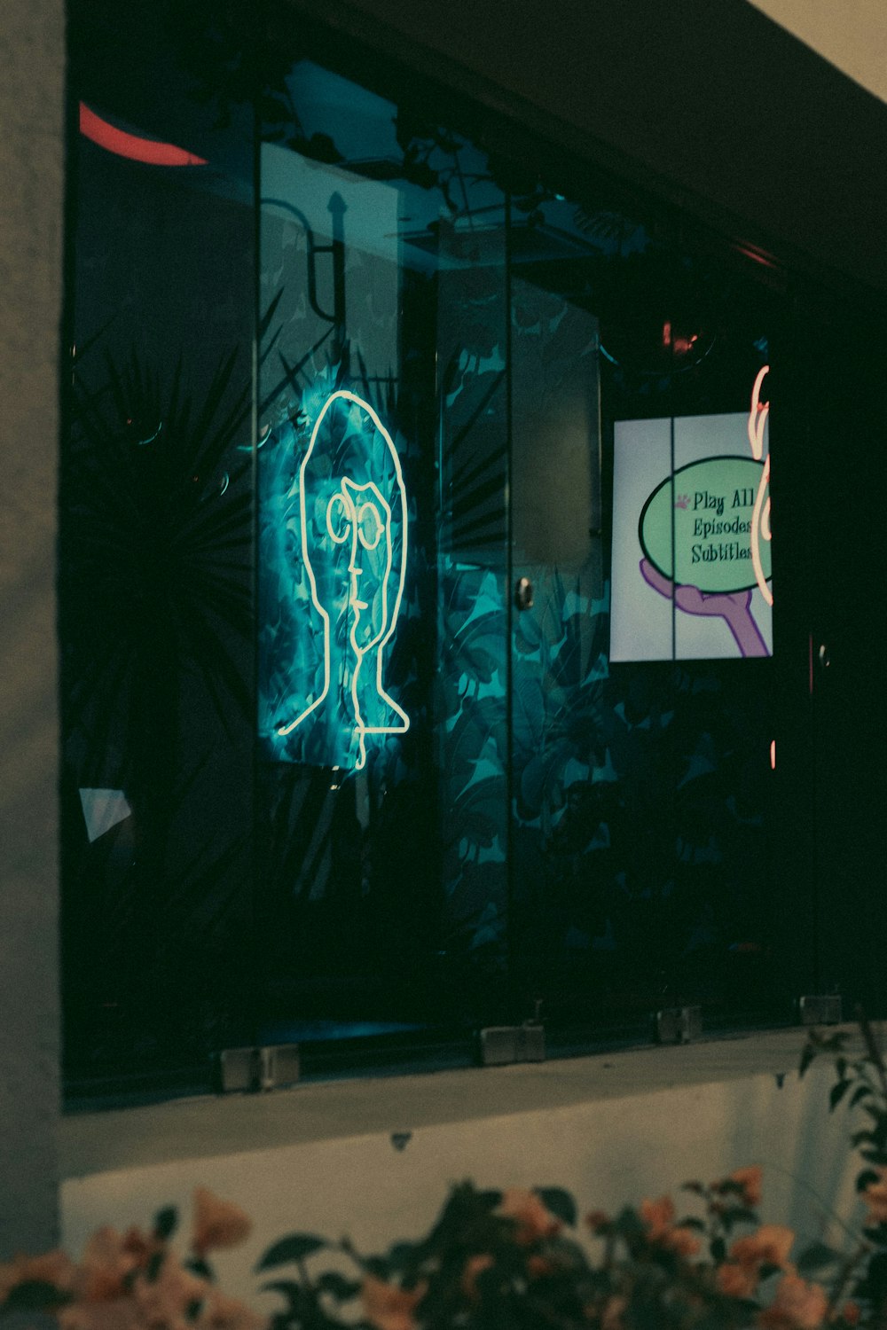 a neon sign in the window of a store