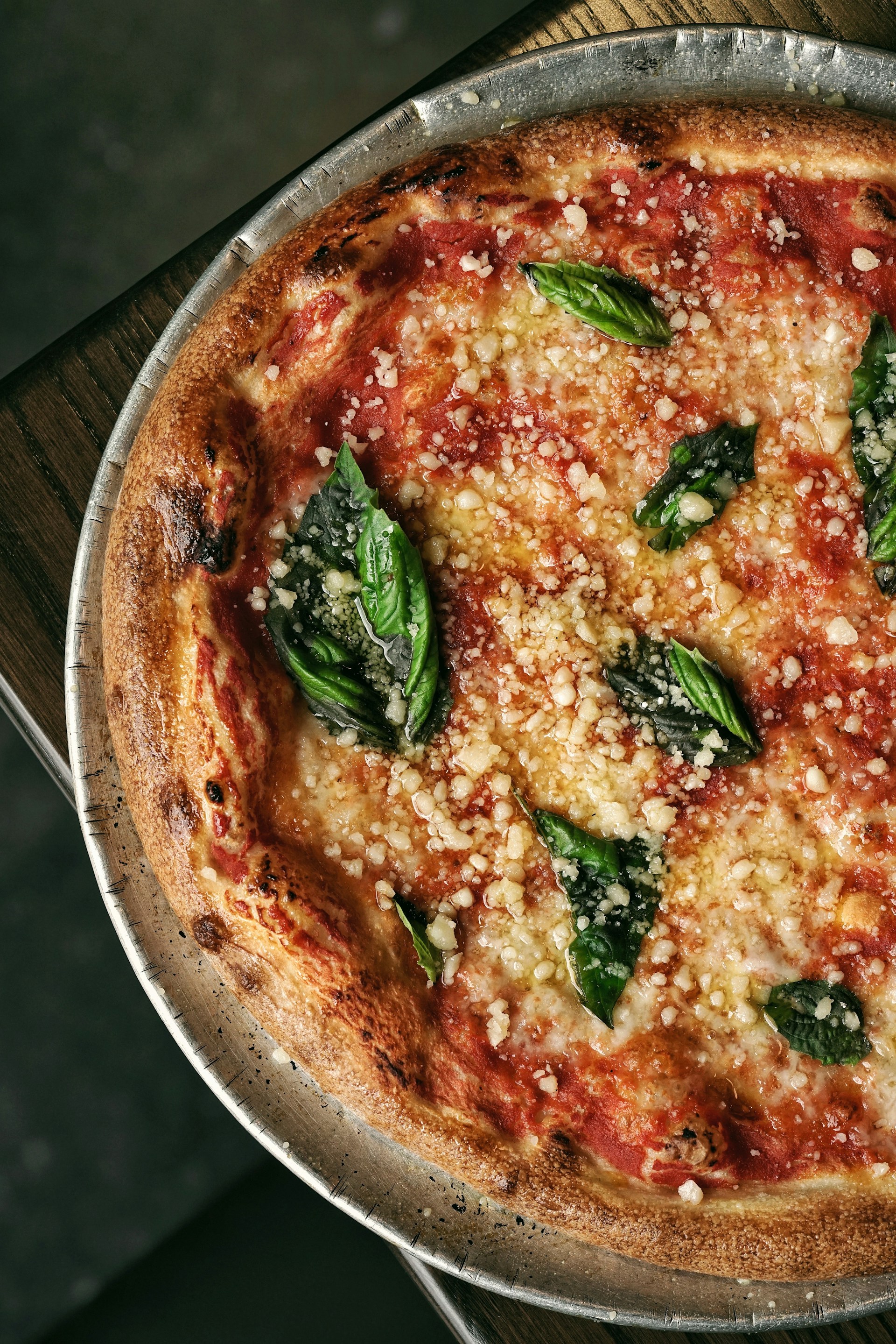 A mouthwatering margarita pizza topped with fresh basil and melted cheese, ready to be enjoyed.