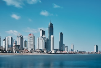 a view of a city with a body of water in front of it