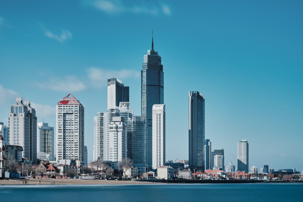 a view of a city with tall buildings and a body of water