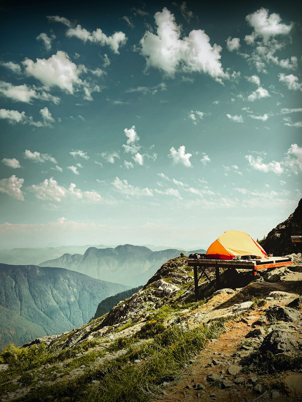a tent set up on top of a mountain