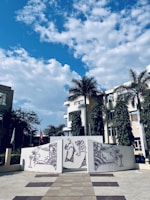 An outdoor scene featuring a mural with colorful patterns.