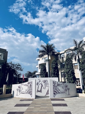 An outdoor scene featuring a mural with colorful patterns.