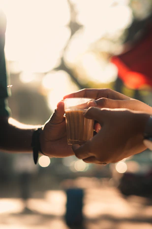 A warm scene of a caregiver and elderly client sharing a cup of tea by a window.