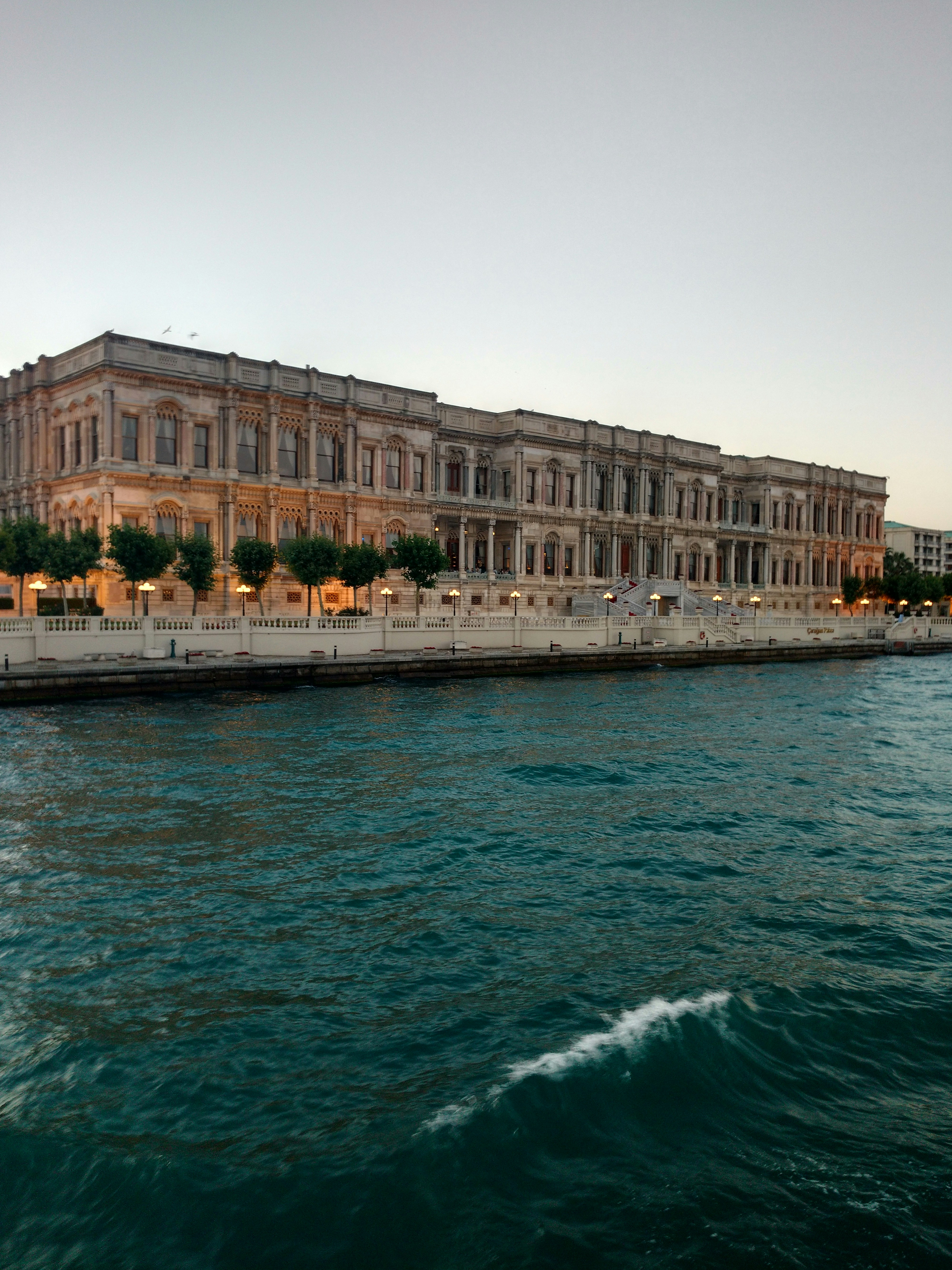 a large building sitting on the side of a body of water