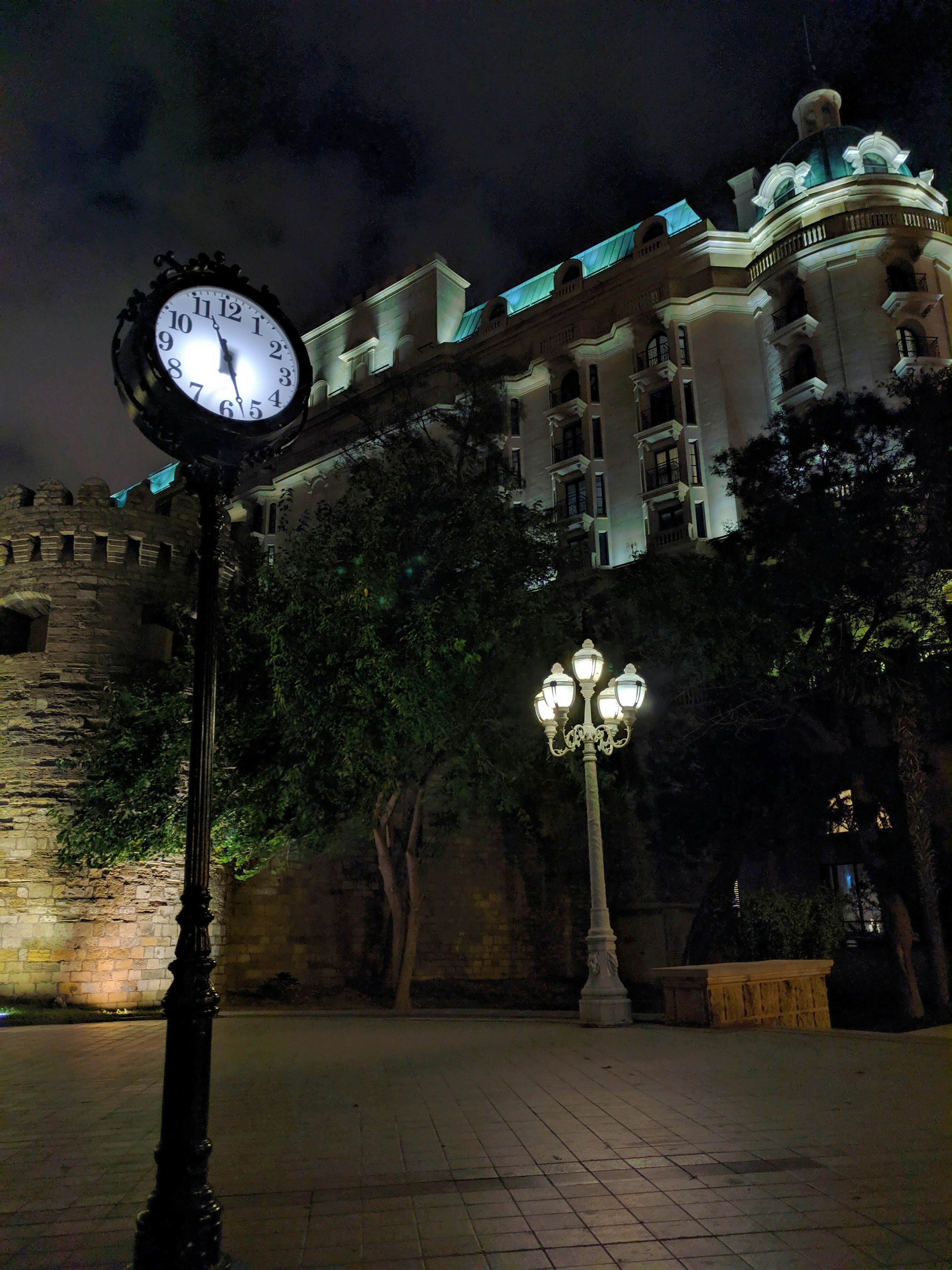 a clock on a pole in front of a building