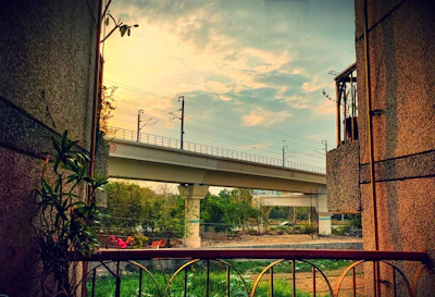 Evening shot of a railway bridge with concrete forms and safety barriers in place.