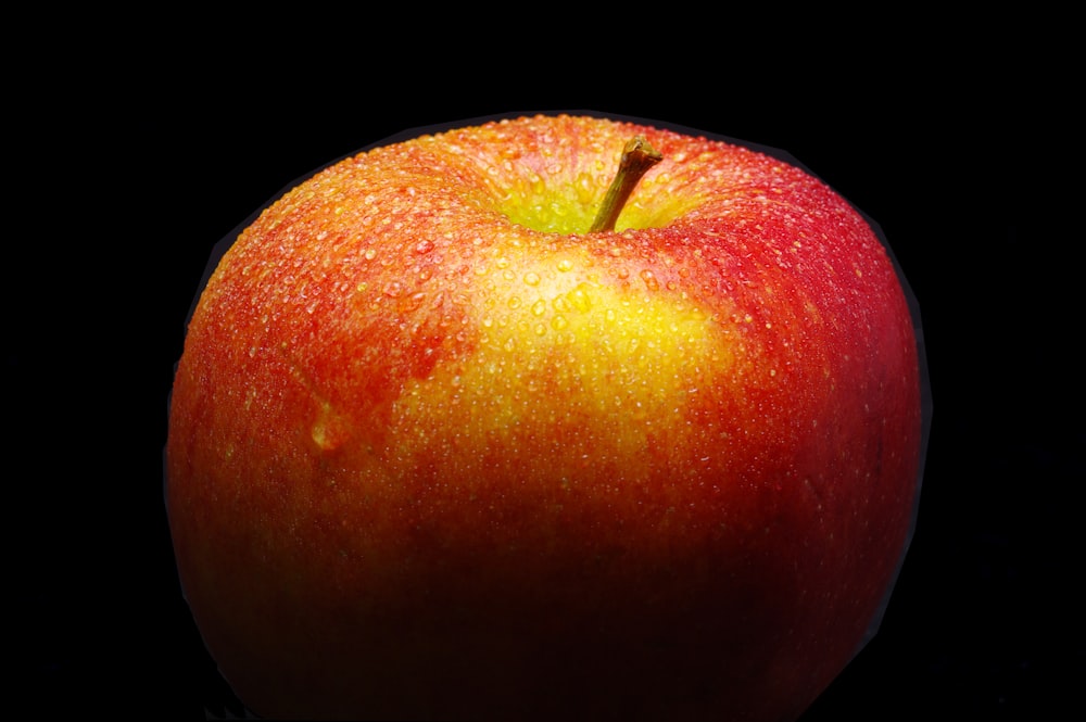 a close up of an apple on a black background