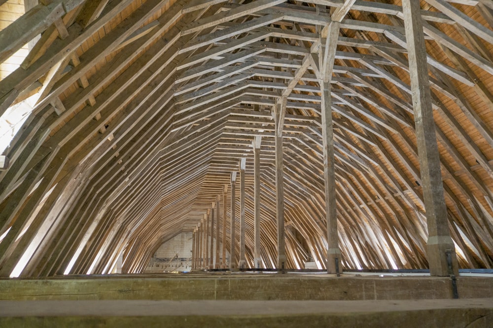 the inside of a building with wooden beams