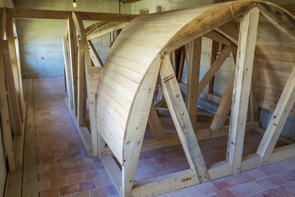 a row of wooden boats sitting on top of a floor