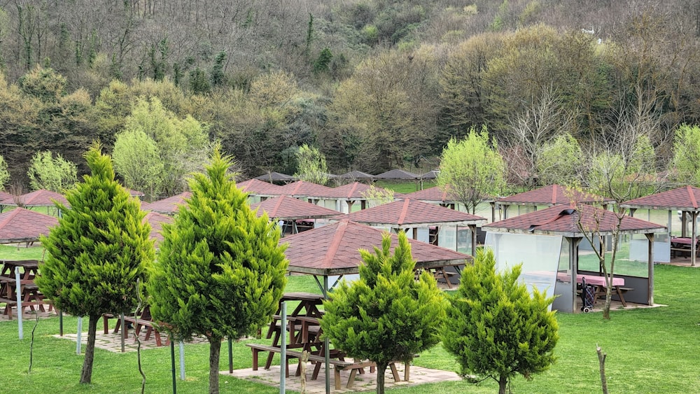 a group of buildings sitting on top of a lush green field