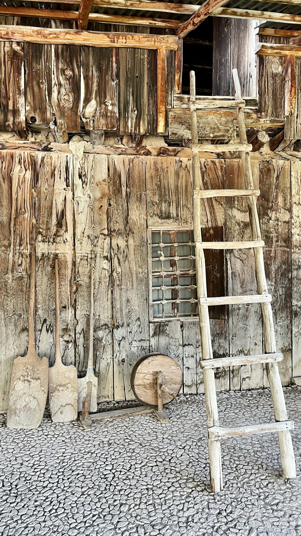 a ladder leaning up against a wooden wall