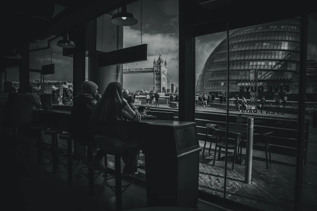 A cozy urban café in Saint-Étienne with people chatting and laughing, capturing the city's friendly vibe.