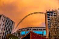 A dramatic sunset behind the Maracanã stadium filled with Flamengo supporters.