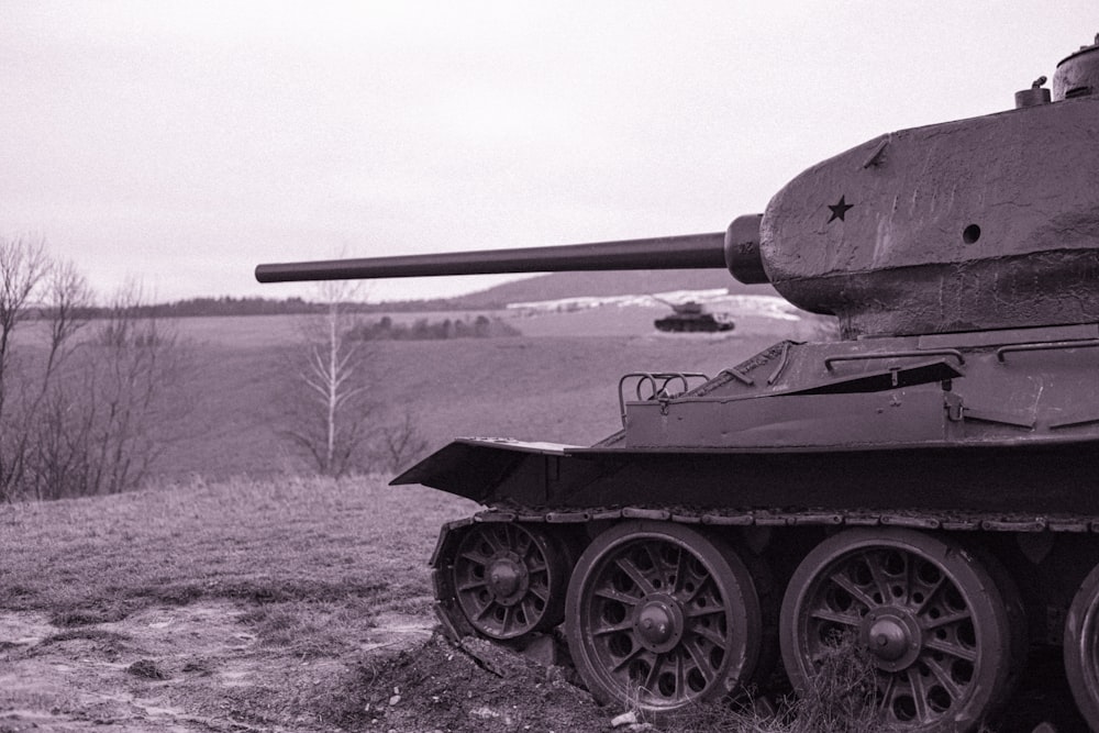 a black and white photo of a tank in a field