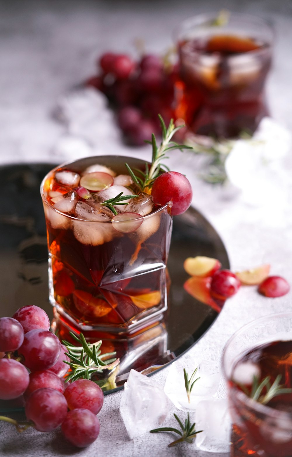 a glass of wine and some grapes on a table