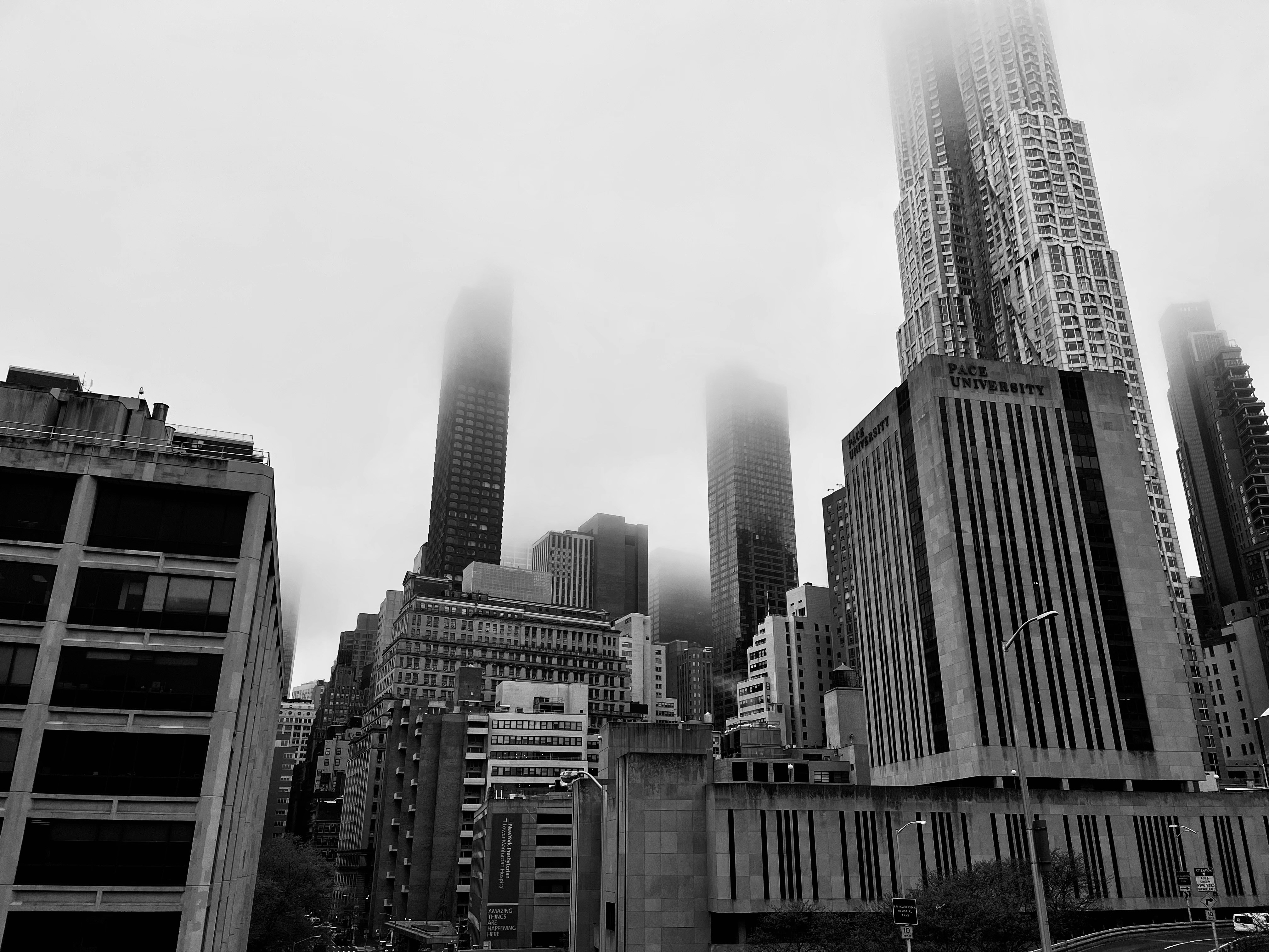 a black and white photo of a city with tall buildings