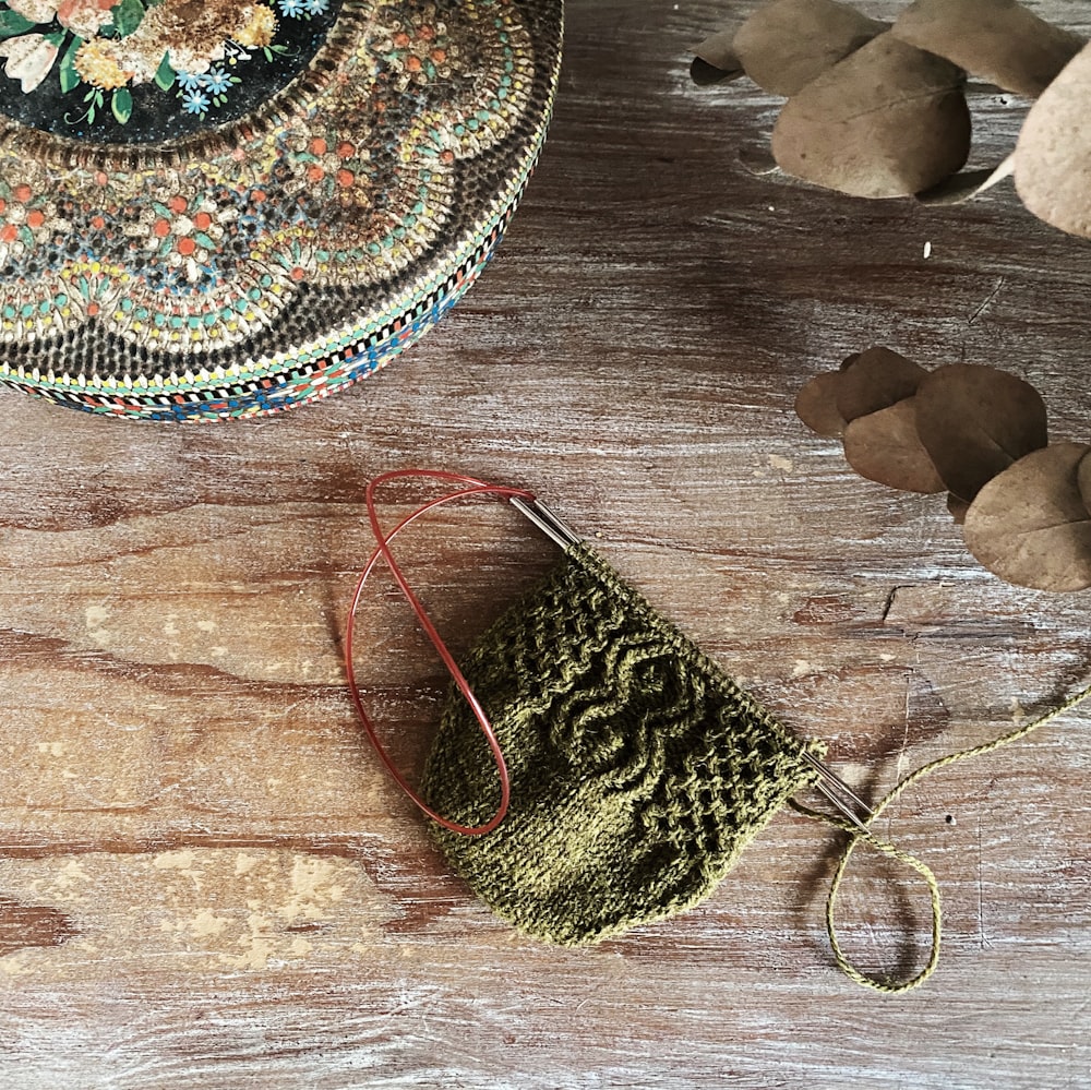 a green bag sitting on top of a wooden table