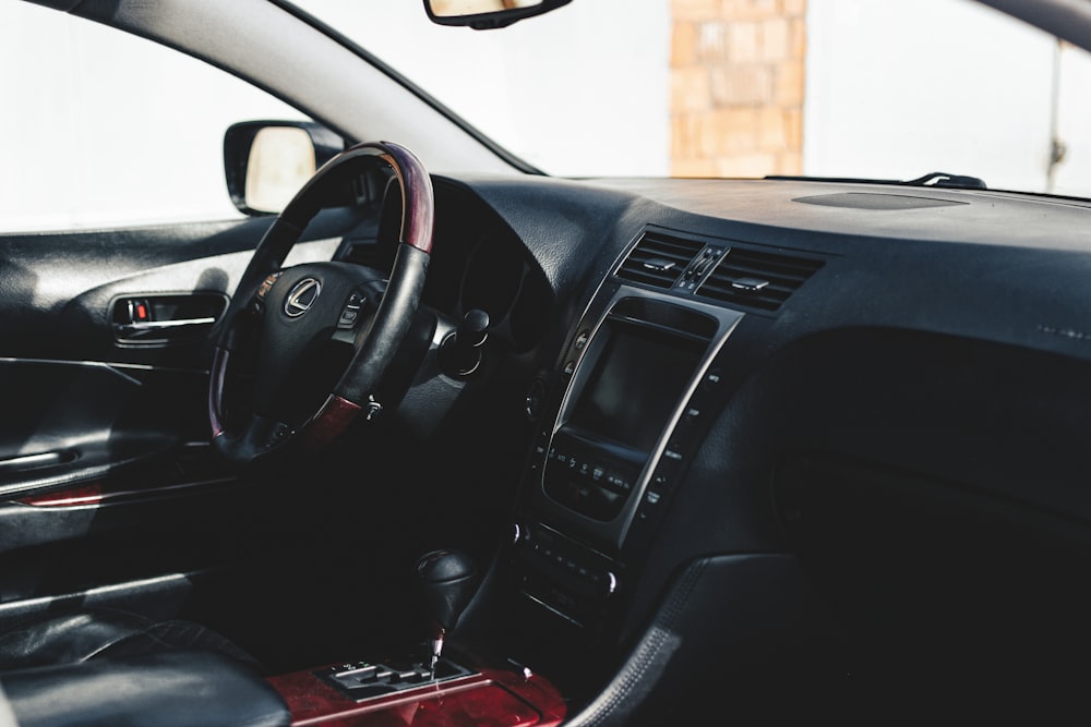 the interior of a car with a steering wheel and dashboard