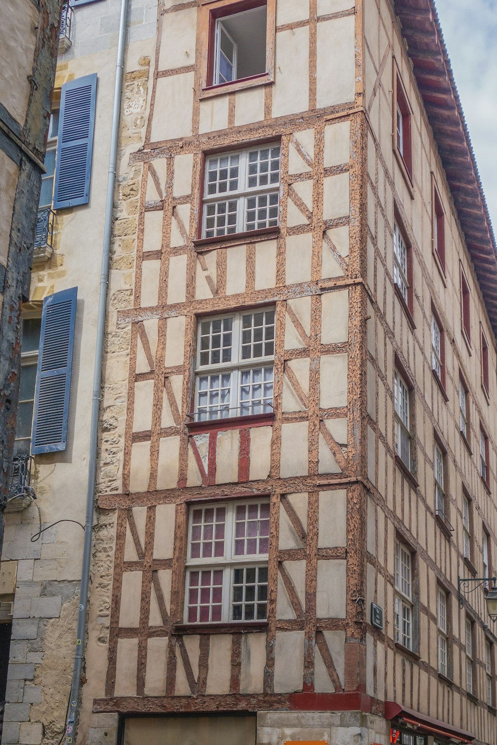 a tall building with lots of windows next to a street