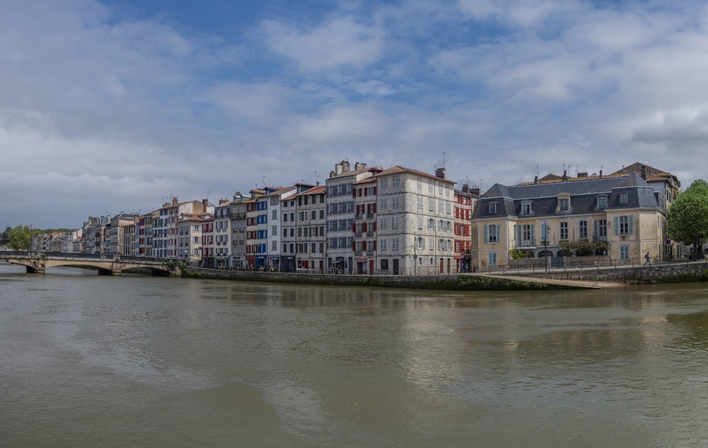 a river running through a city next to tall buildings