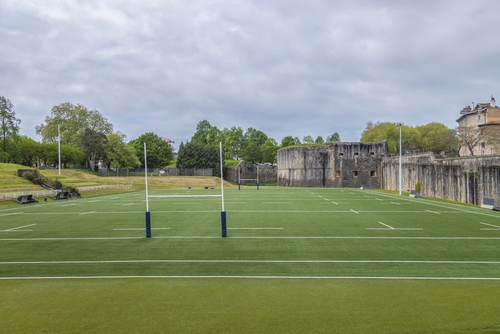 a tennis court with a castle in the background