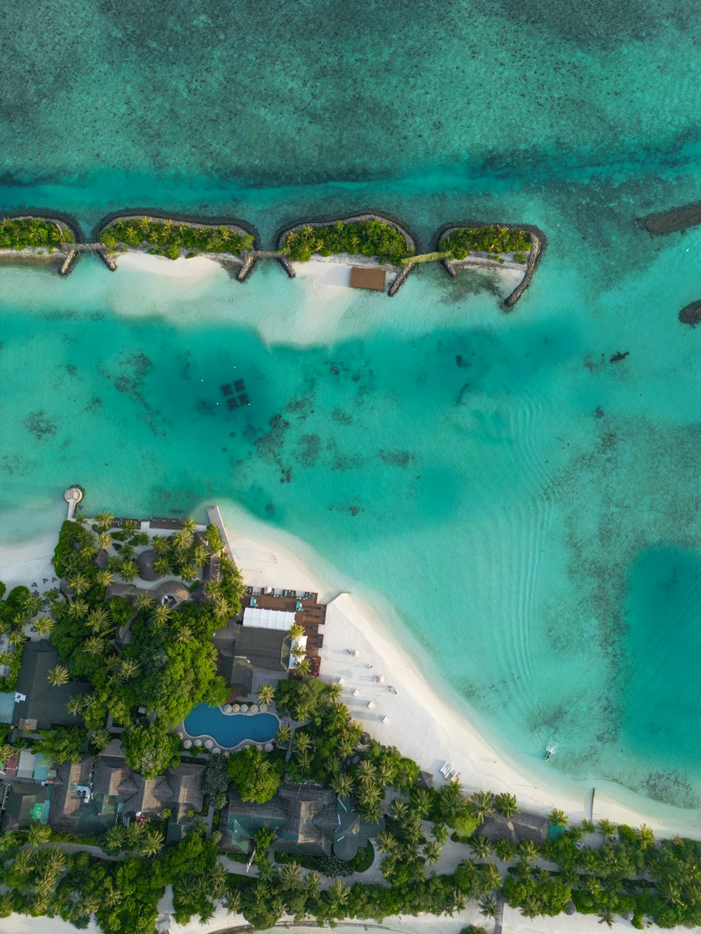 an aerial view of a resort on a tropical island