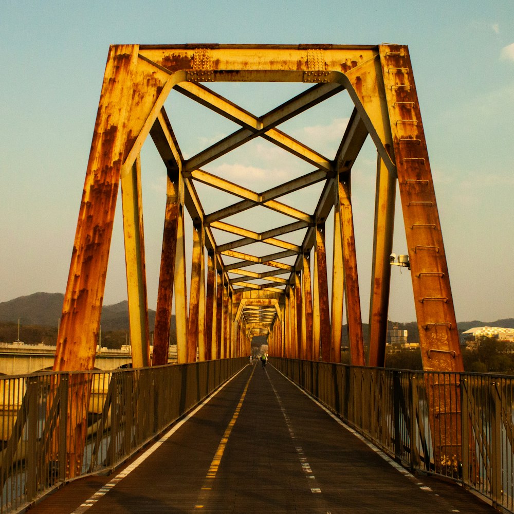 a long bridge with a car going over it