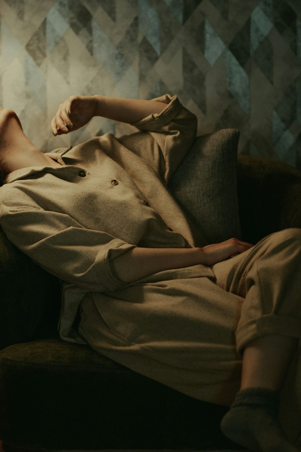 a woman laying on a couch in a room