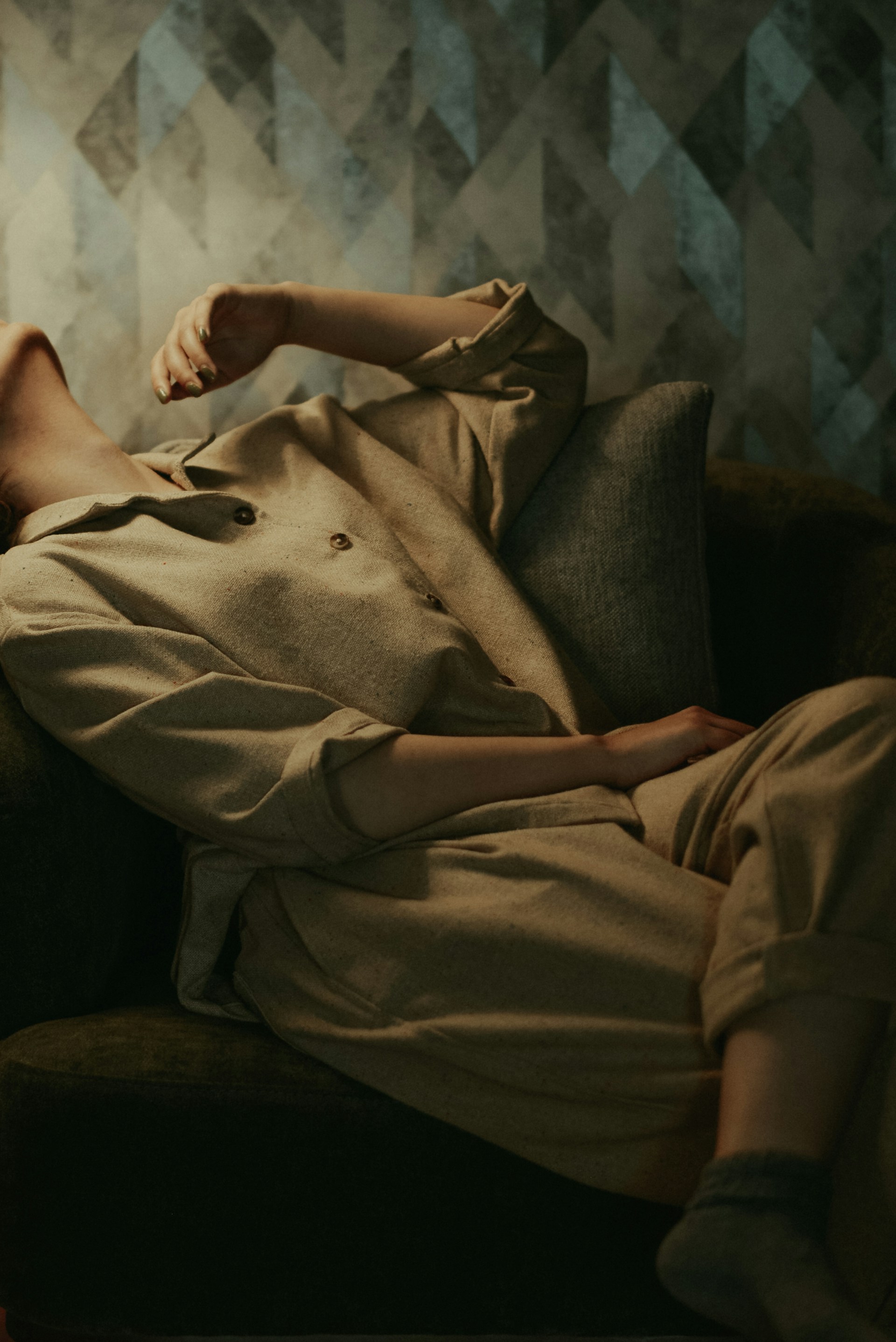 a woman laying on a couch in a room