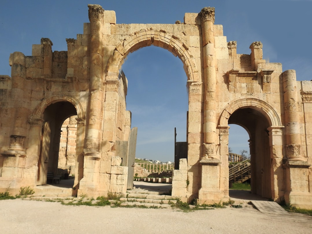 an old stone building with two archways,